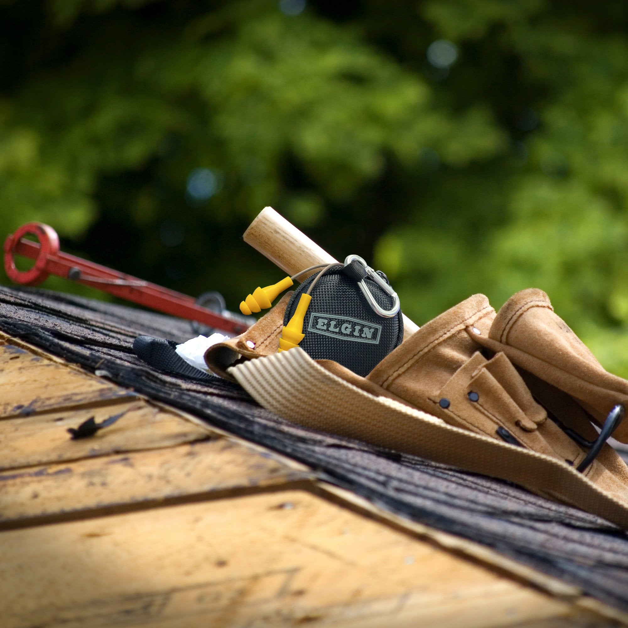 A roofers tool belt with the Elgin Ruckus Wired In-Ear Earbuds with mic Elgin® USA